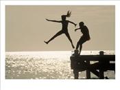 Silhouette-of-Girls-Jumping-off-Pier-Photographic-Print-C11972341